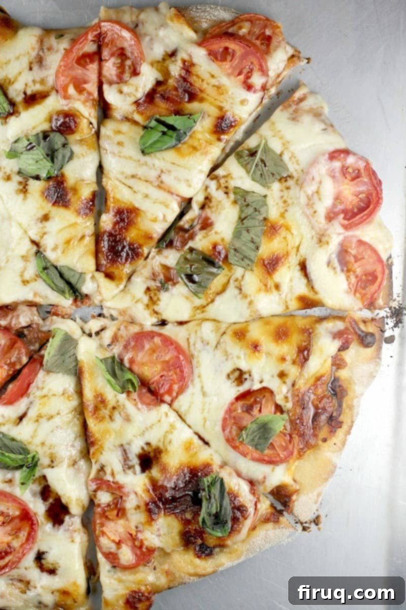 Perfect Pizza Margherita on the Big Green Egg 3 top down view of half the cooked pizza, sliced into portions
