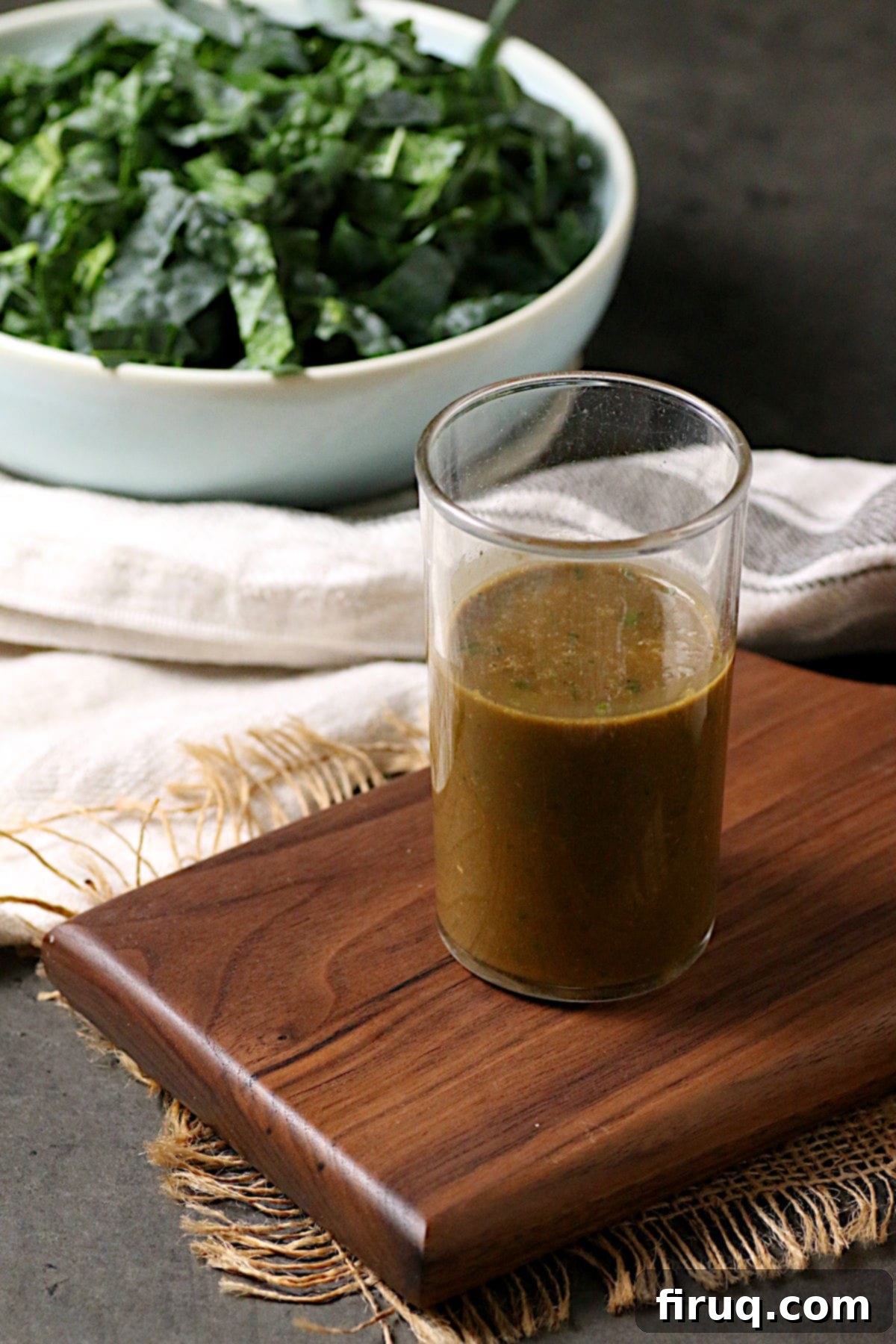 Fresh Basil Balsamic Vinaigrette in a Jar A clear glass jar filled with a vibrant green Basil Balsamic Vinaigrette, ready for serving or storage.