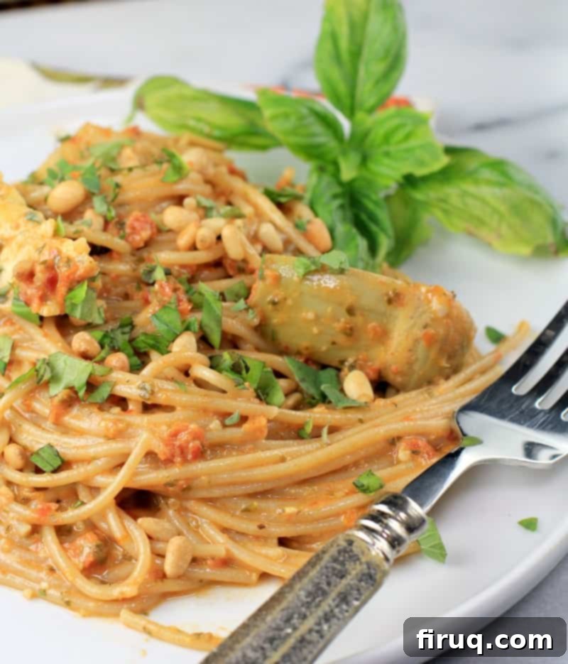 Rich Sun Dried Tomato Pesto Pasta 11 plated pasta on a white plate with a fork