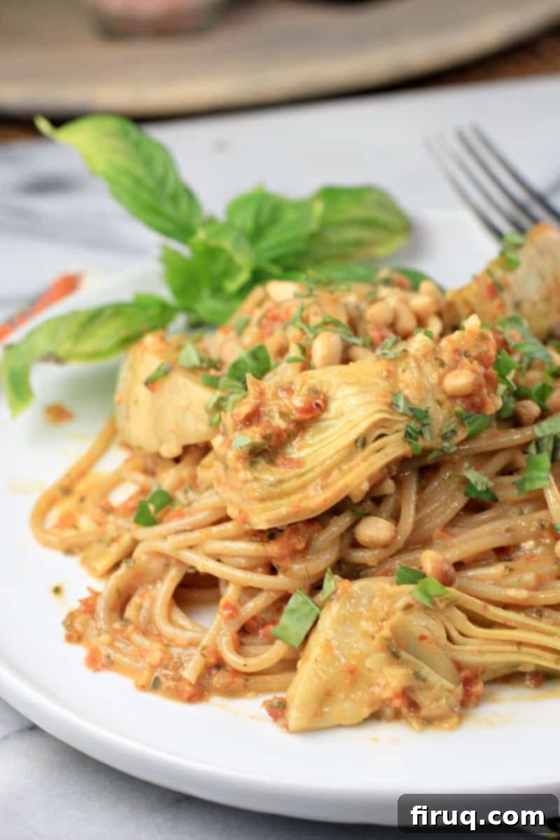 Rich Sun Dried Tomato Pesto Pasta 13 plated sun dried tomato pesto pasta on a white plate