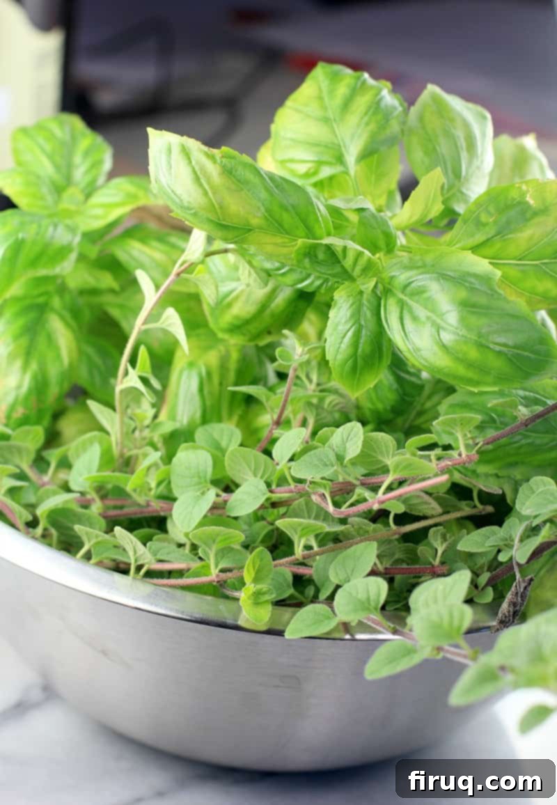Rich Sun Dried Tomato Pesto Pasta 5 fresh basil and oregano in a metal bowl