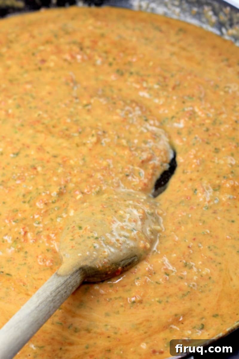 Rich Sun Dried Tomato Pesto Pasta 8 vegan sun-dried tomato pesto sauce in a skillet with wooden spoon