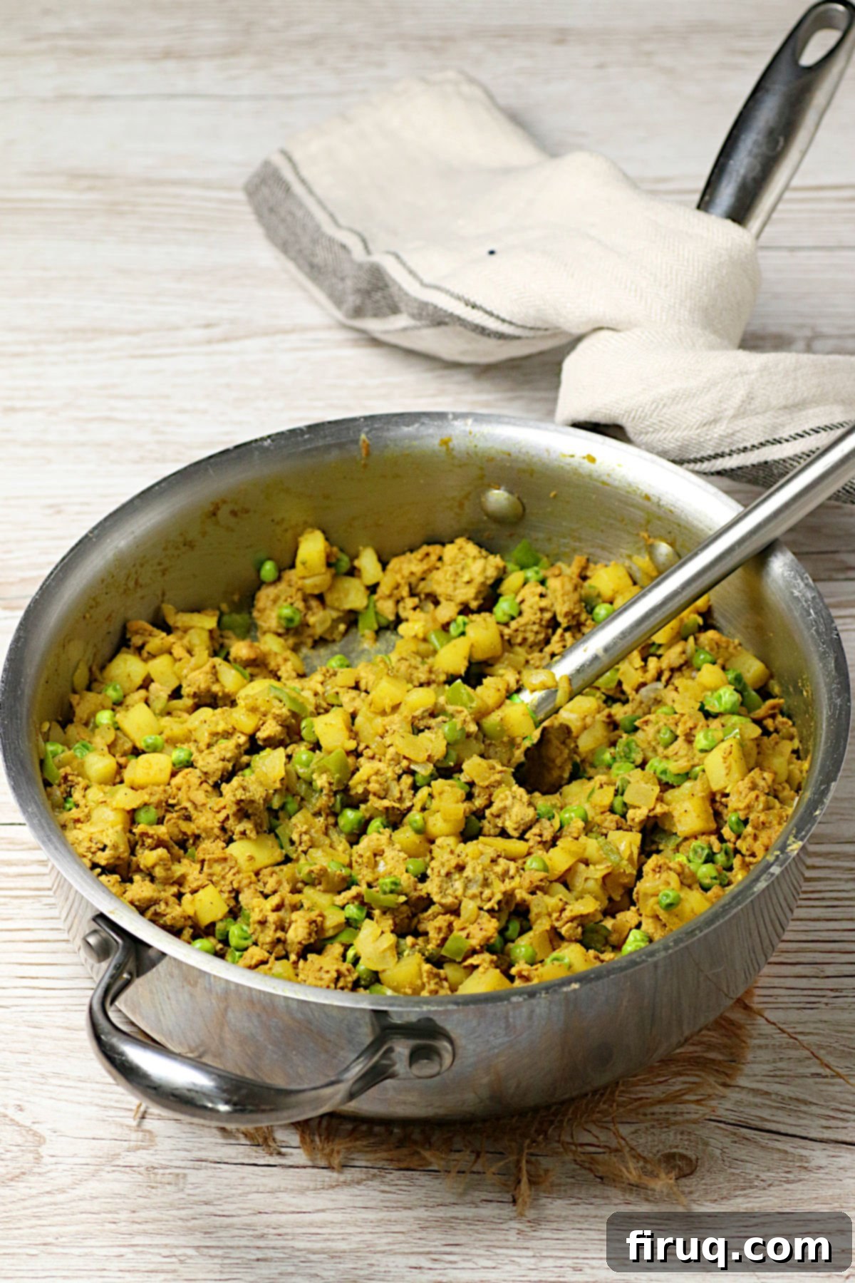 Samosa Pie Filling in Pan Cooked Chicken Samosa Pie filling in a saute pan.