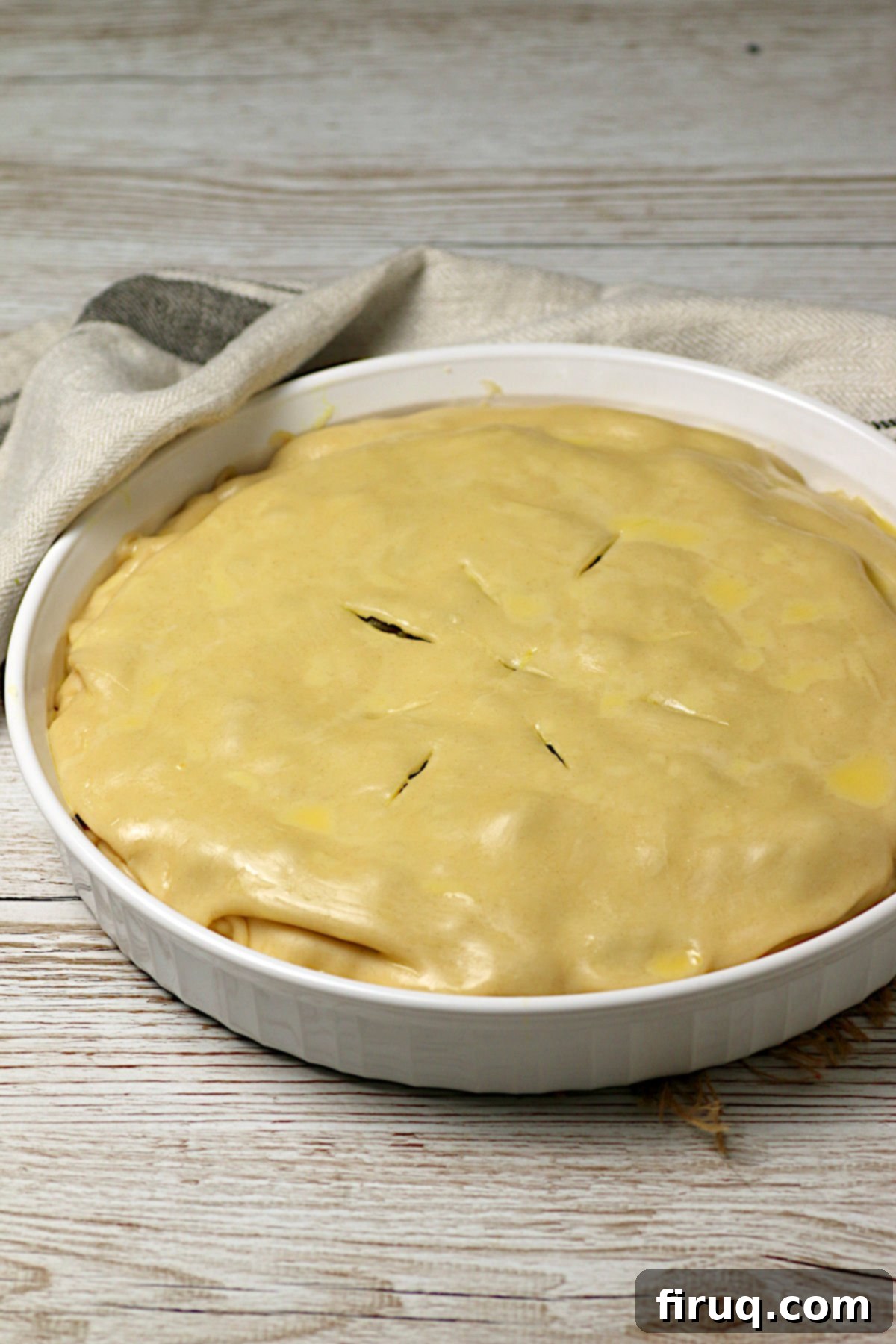 Unbaked Chicken Samosa Pie An unbaked Chicken Samosa Pie in a white tart dish.