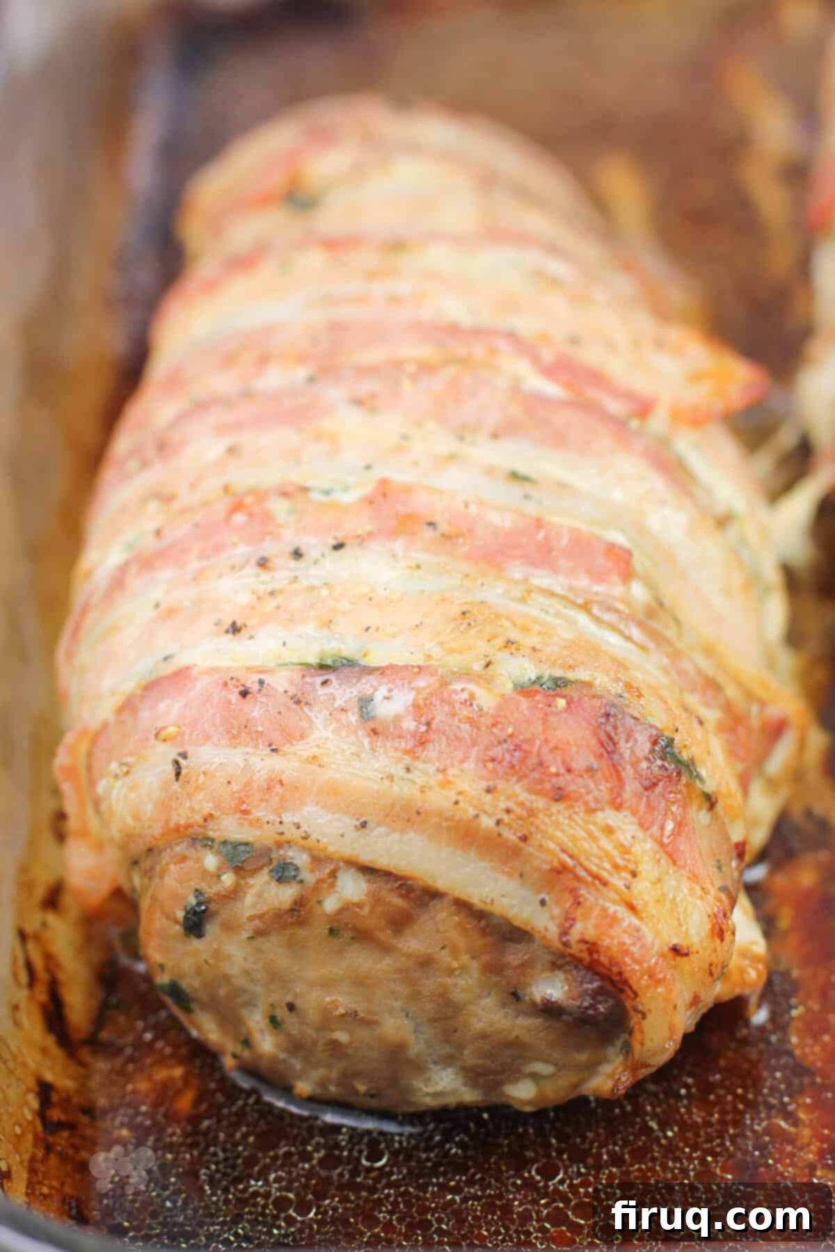 Easy Weeknight Roasted Pork Tenderloin 3 close view showing bacon wrapped around cooked pork