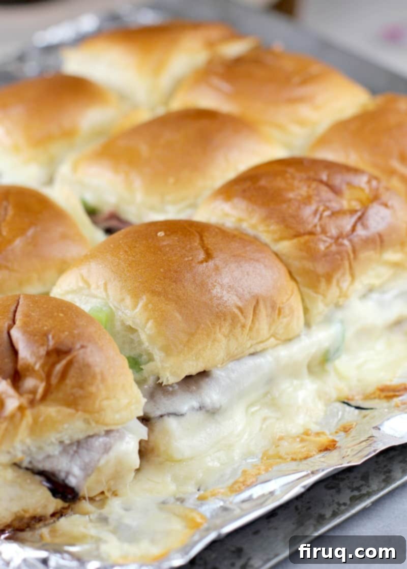 Grilled Philly Cheesesteak Bites 10 A whole block of assembled Philly cheesesteak sliders resting on aluminum foil, ready for the grill.