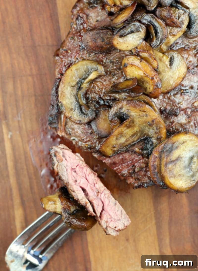 Savory Grilled Mushroom Delights 9 top view of finished steak cut with fork holding a piece to show doneness