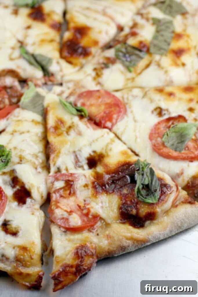 Aromatic Grilled Honey Thyme Biscuits 5 Classic Big Green Egg Pizza Margherita, freshly sliced and ready to eat.