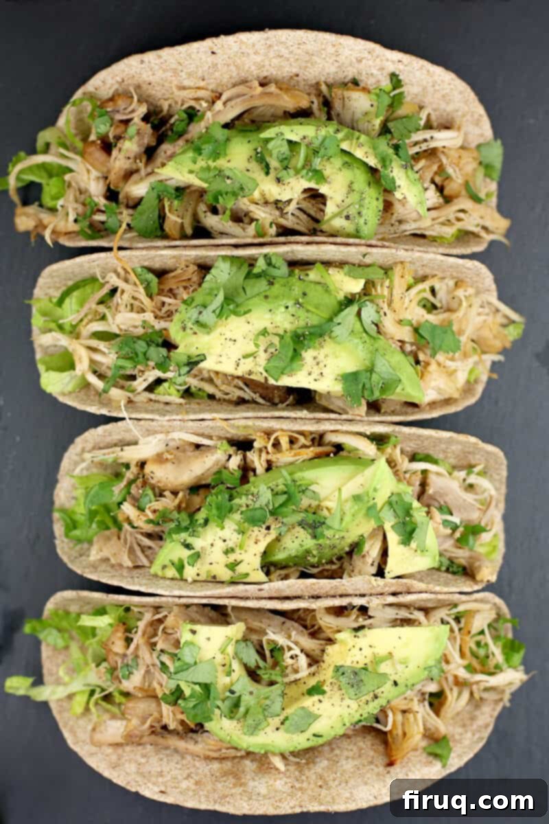 Instant Pot Chicken Carnitas 14 top down view of 4 chicken tacos on a slate platter