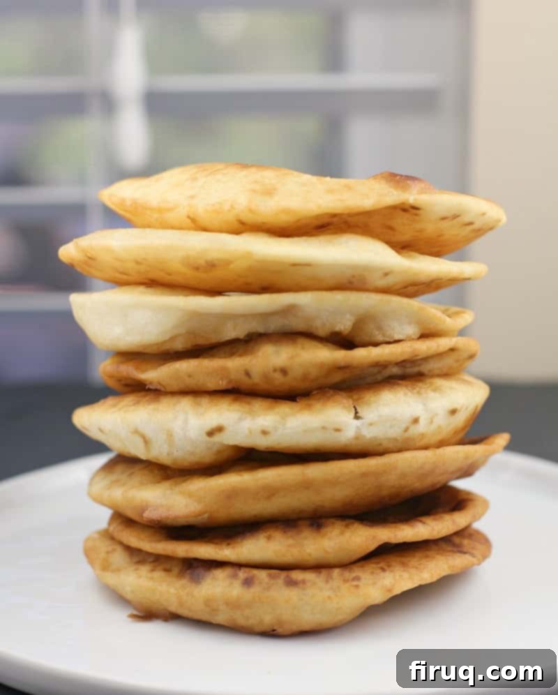 Huevos Rancheros Benedict 4 Stack of freshly fried street taco flour tortillas on a white plate, golden and crispy