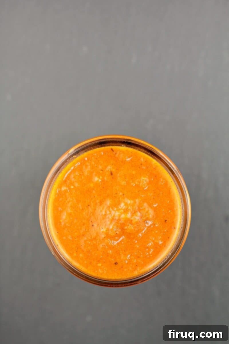 Sunrise Ranchero Kick 8 small mason jar filled with huevos ranchero sauce on slate background
