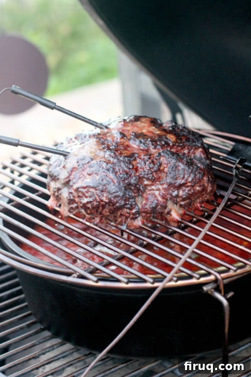 Ultimate Smoked Chili 2 large loaf of smoked ground beef on grill grate in Big Green Egg with temperature probes sticking out