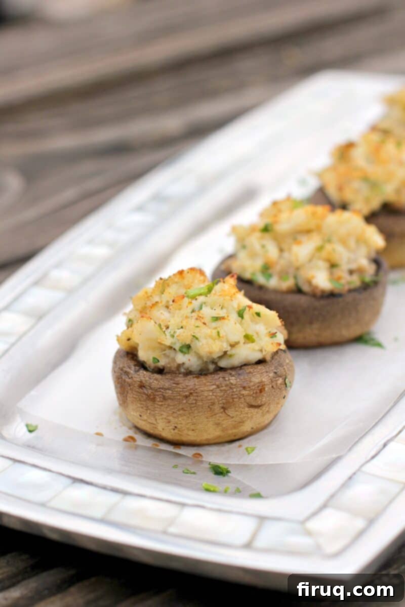 Crab-Filled Mushroom Caps 11 crab stuffed mushroom on a metal dish