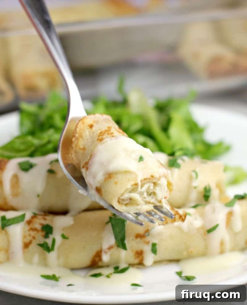 Crab-Filled Mushroom Caps 7 piece of crab-stuffed crepe on a fork