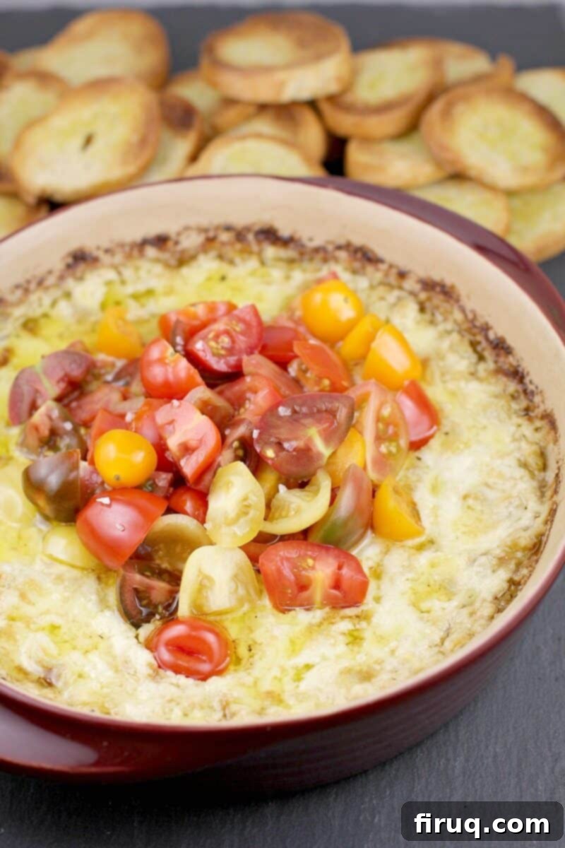 Warm Green Chili Artichoke Dip 13 baked artichoke dip in bake dish with crostini in the background