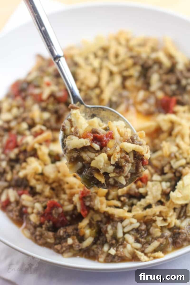 Adventure Sloppy Joes 2 spoon lifting up rehydrated backcountry sloppy joes