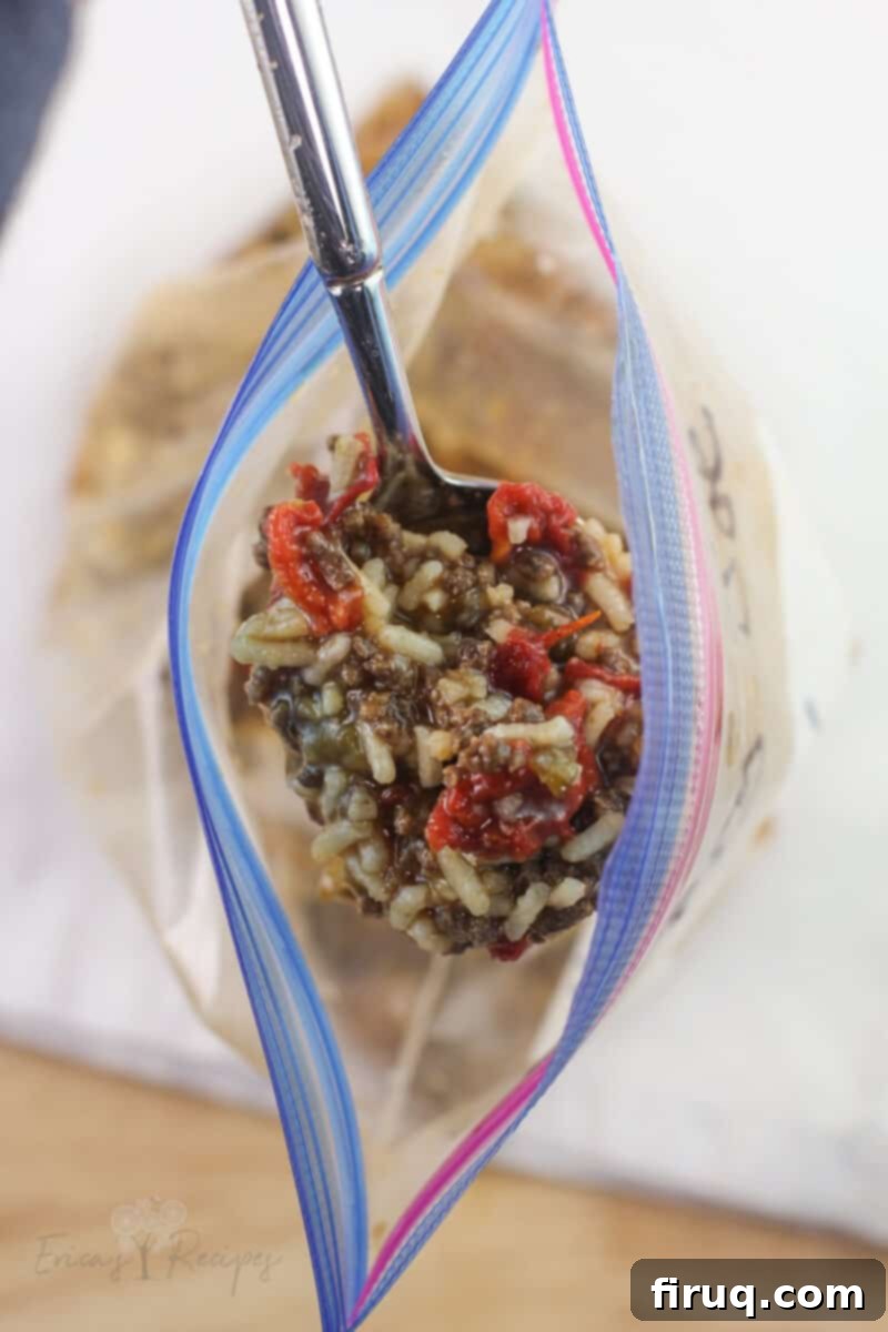 Adventure Sloppy Joes 3 open ziploc bag with spoon lifting up prepared sloppy joes
