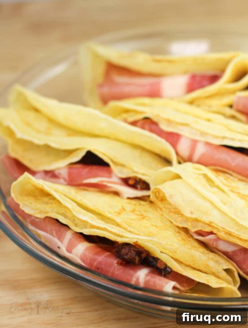 Prosciutto and Cheese Crepes 6 folded crepes in clear glass plate