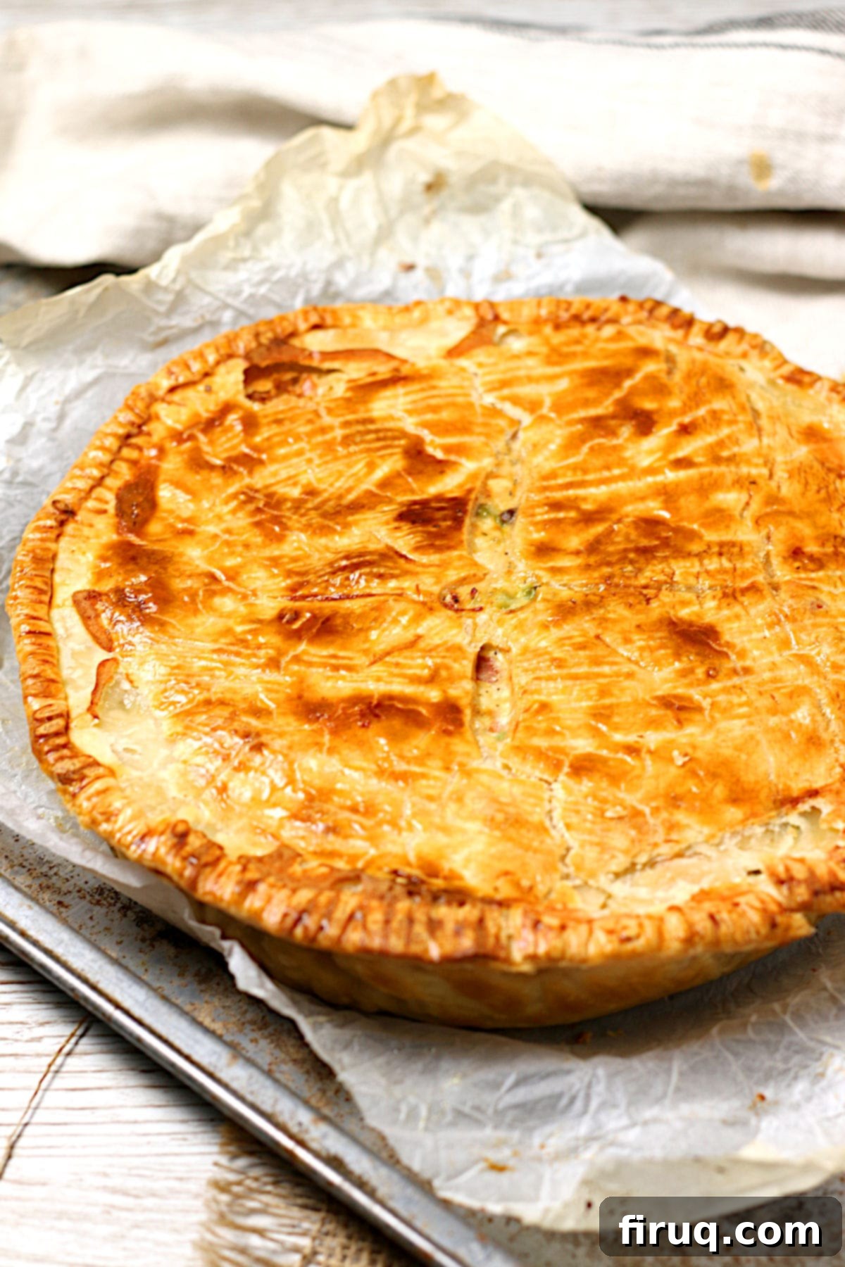 Whole Chicken Pot Pie on Baking Sheet A whole homemade Chicken Pot Pie on a baking sheet, golden brown and inviting.