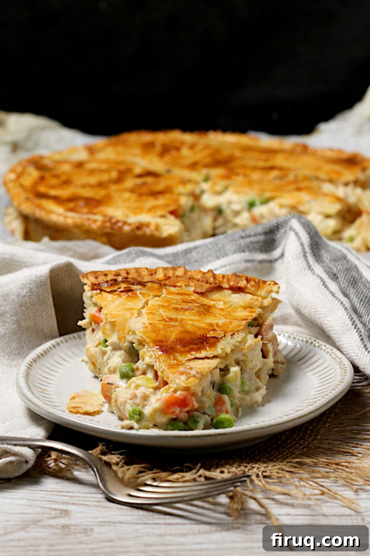 Chicken Pot Pie Slice Another perspective of a slice of homemade Chicken Pot Pie on a small white plate.