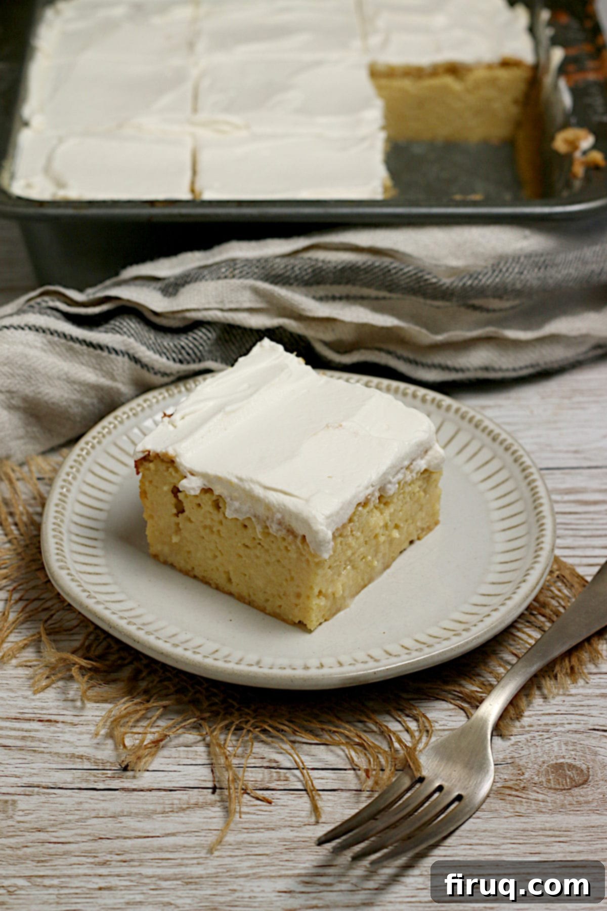 Gluten-Free Corn Tres Leches Cake Slice A slice of Gluten-Free Corn Tres Leches Cake on a small white plate.