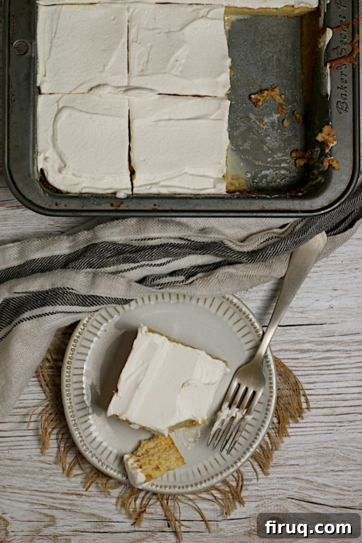 Overhead Gluten-Free Corn Tres Leches Cake Slice Overhead photo of a slice of Gluten-Free Corn Tres Leches cake on a small white plate.