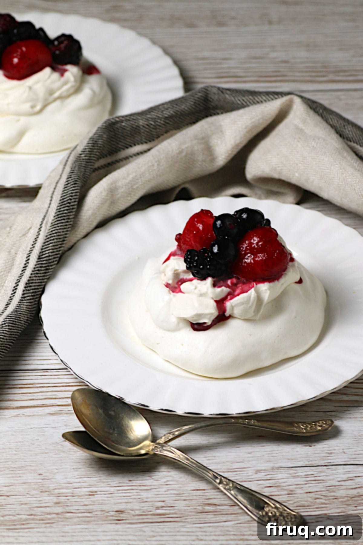 Mixed Berry Pavlova Mixed Berry Pavlova on a white plate.