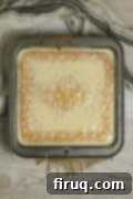 Milk Soak Absorption Overhead photo of a gluten-free corn tres leches cake immediately after pouring on the milk soak.