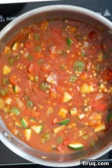 Eggs and Lentils: Your New Power Breakfast 6 crushed tomatoes and water added to pan