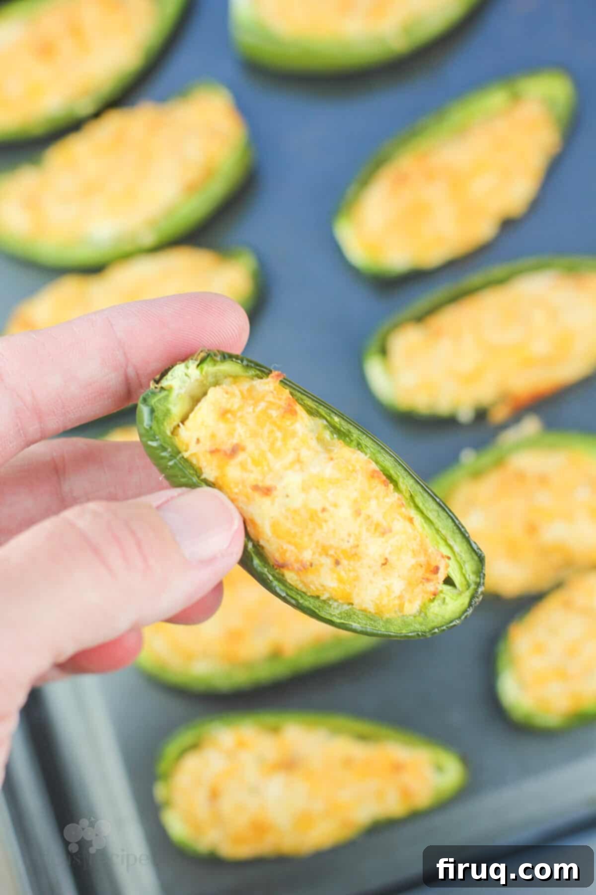 Spicy Shrimp Jalapeño Poppers 3 hand holding a cooked jalapeno popper
