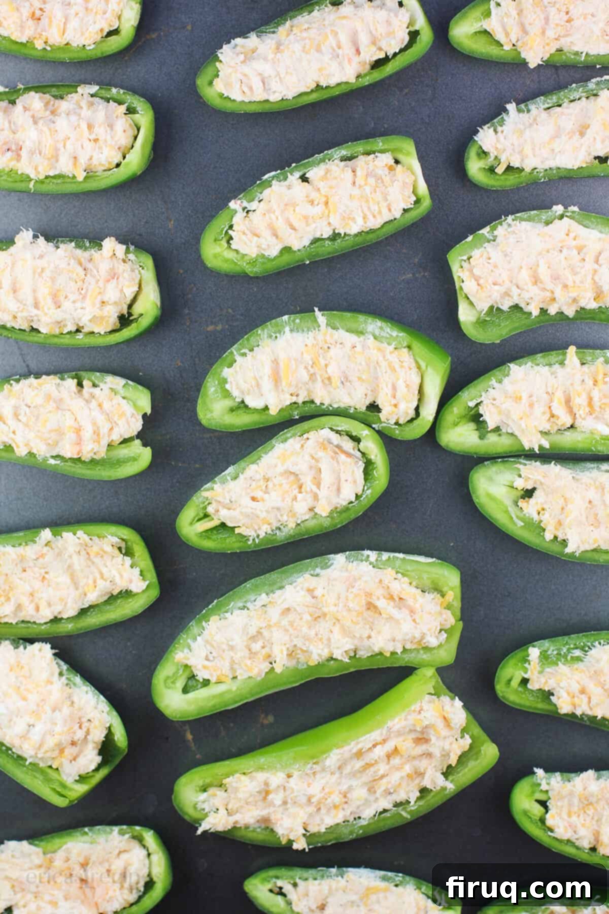 Spicy Shrimp Jalapeño Poppers 6 filled jalapenos on bake sheet before cooking
