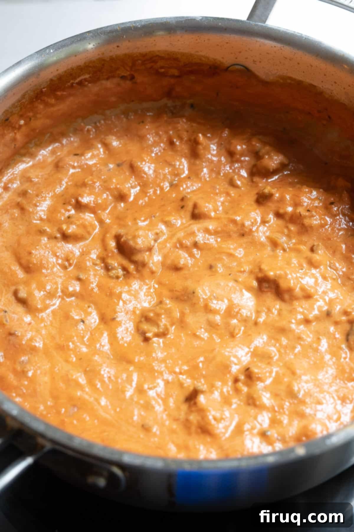 Rosé Sausage Pasta 2 Italian pink sauce with sausage warming in pot.