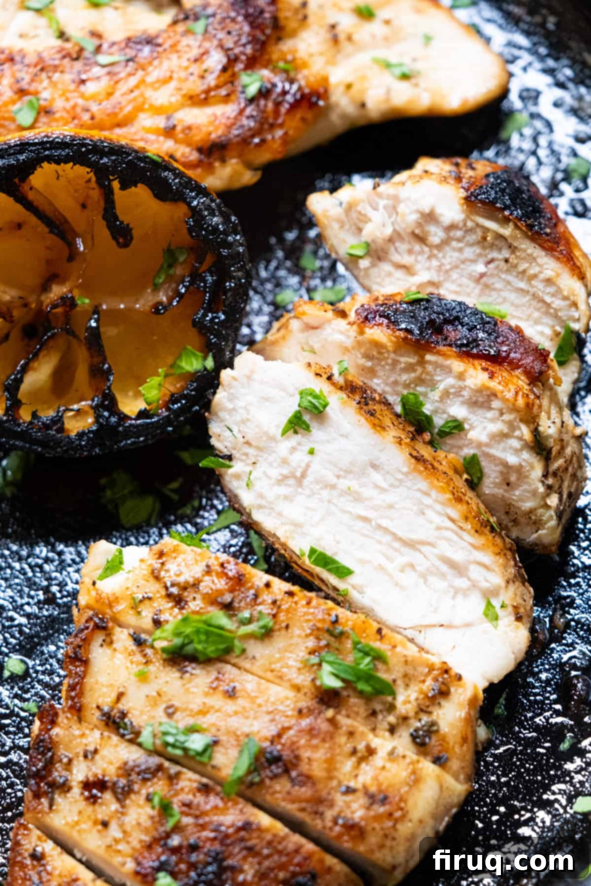 Flawless Cast Iron Chicken Breast 2 Perfectly sliced, golden-brown cast iron chicken breast resting on a cast iron skillet, ready to be served