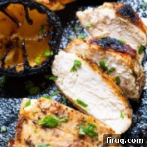 Flawless Cast Iron Chicken Breast 9 Sliced, juicy cast iron chicken breast on a plate with lemon