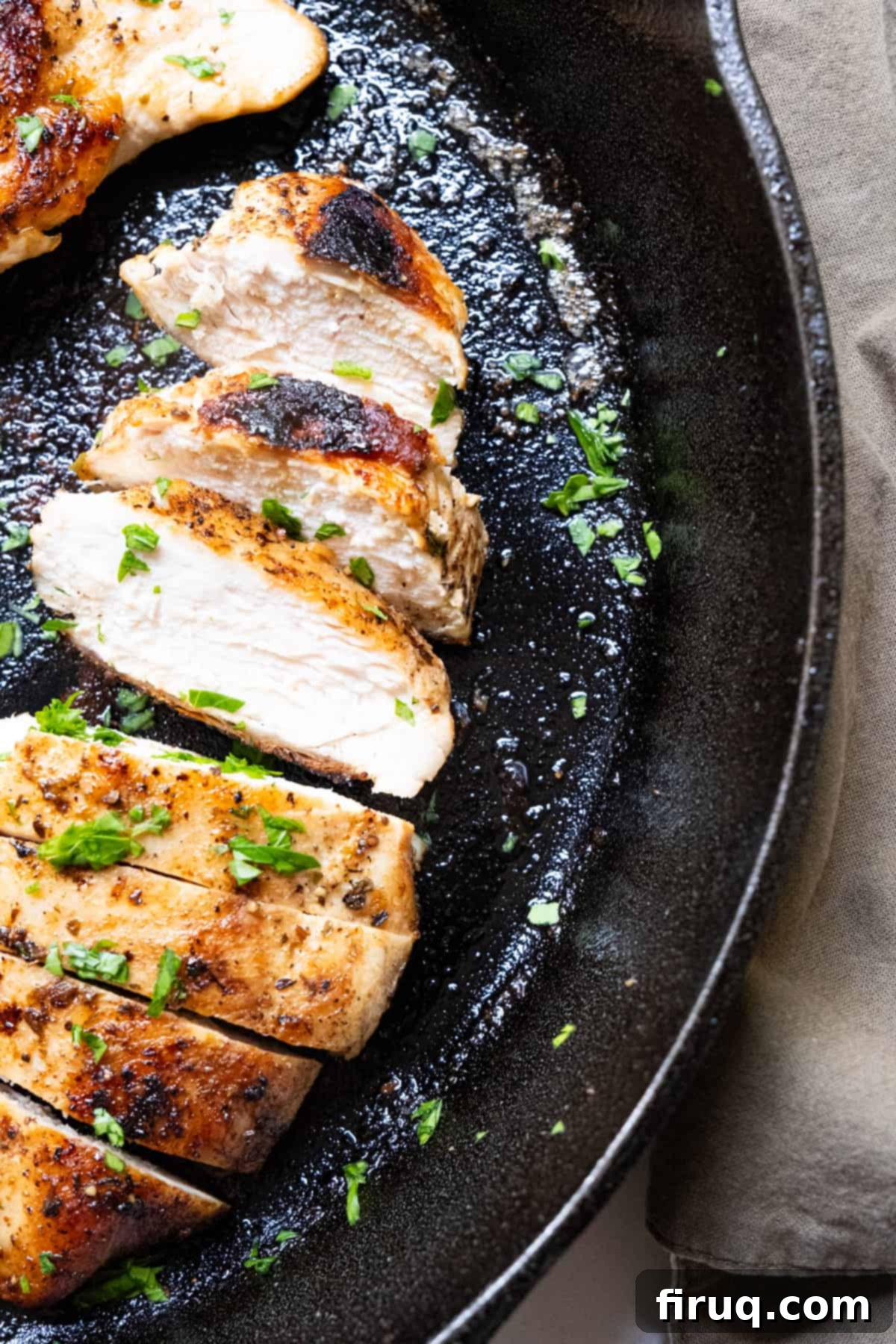 Flawless Cast Iron Chicken Breast 8 Close-up of perfectly sliced, juicy cast iron chicken breast on a cutting board