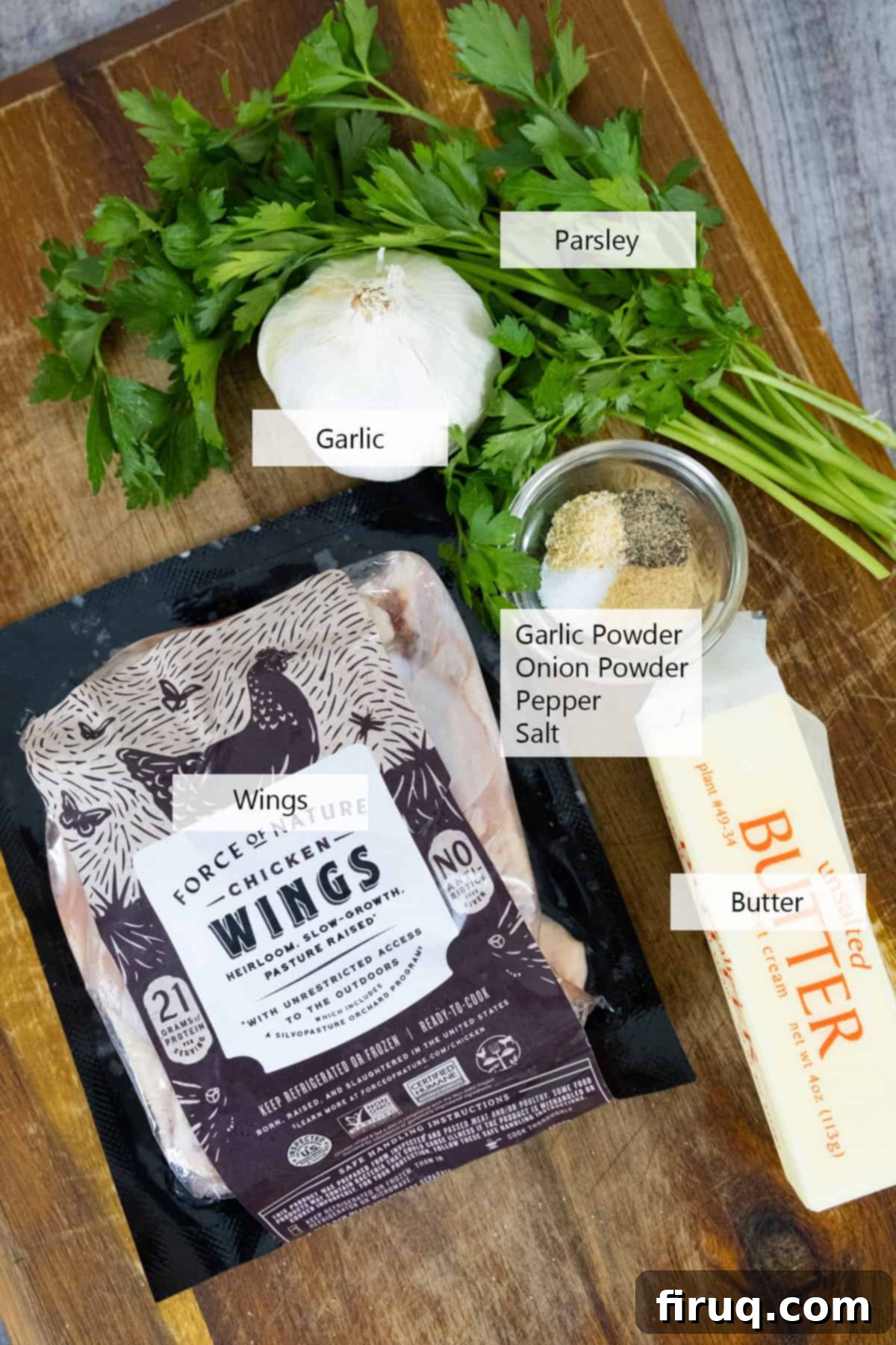 Crispy Air Fryer Garlic Parmesan Wings 3 Fresh ingredients laid out for making air fryer garlic parmesan wings, including raw chicken, fresh garlic, parsley, butter, Parmesan, and seasonings