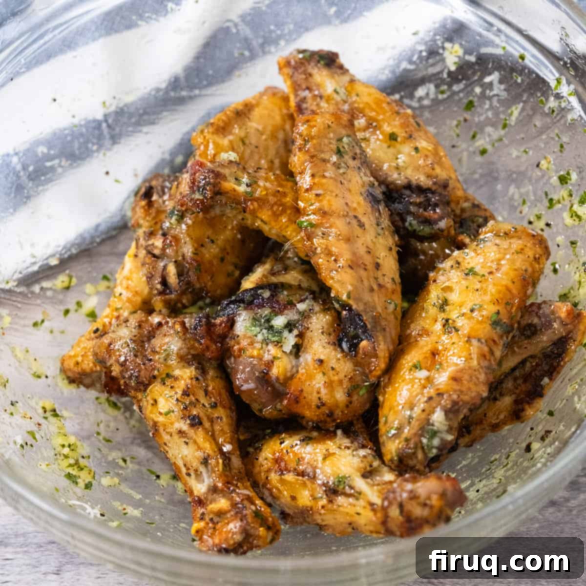 Crispy Air Fryer Garlic Parmesan Wings 7 Close-up of golden-brown air fryer chicken wings generously tossed in a rich garlic parmesan sauce, ready to be devoured