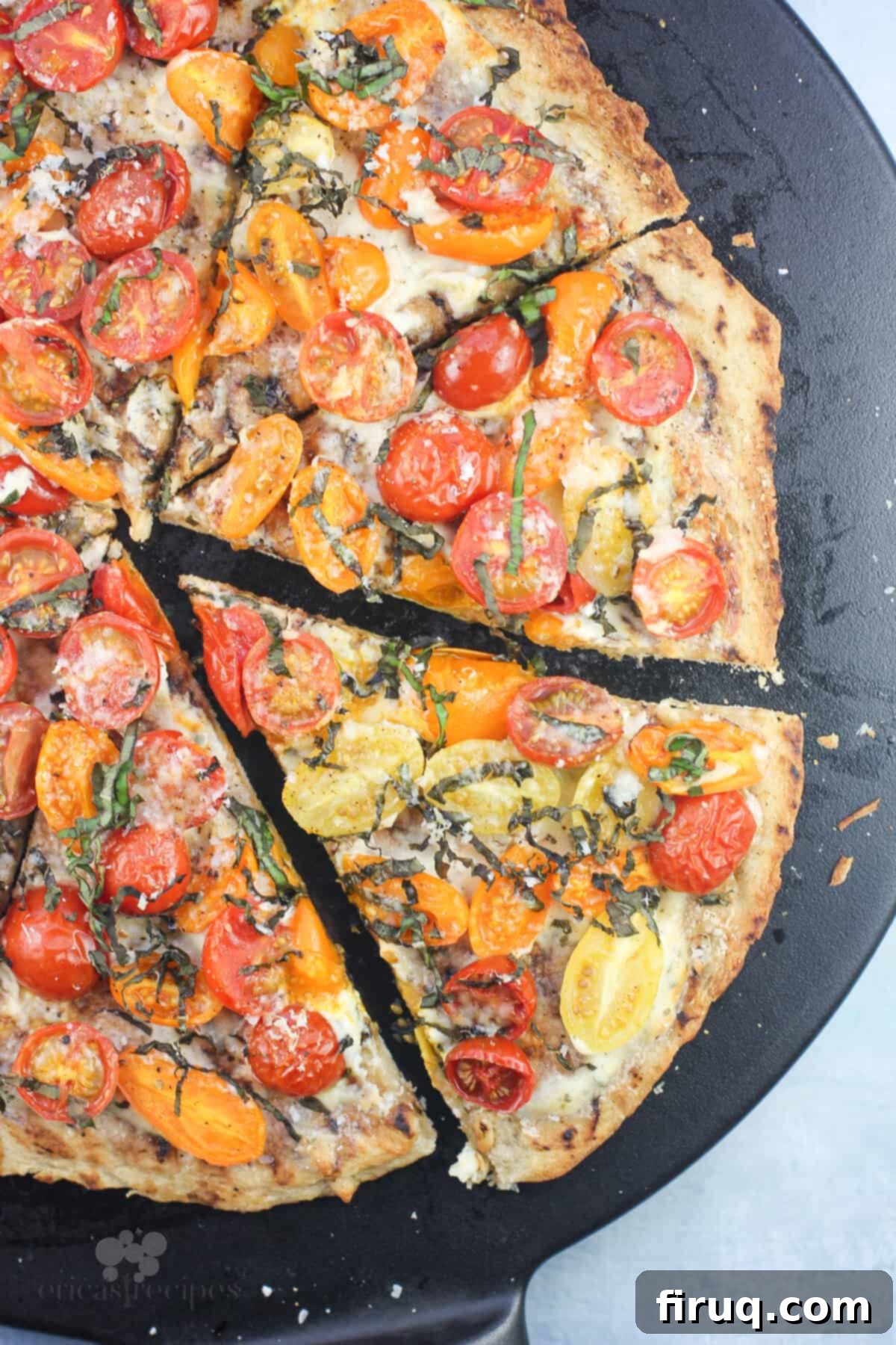 Boursin Bliss: Tomato Basil Pizza 8 top down view showing prepared pizza sliced on black pizza stone