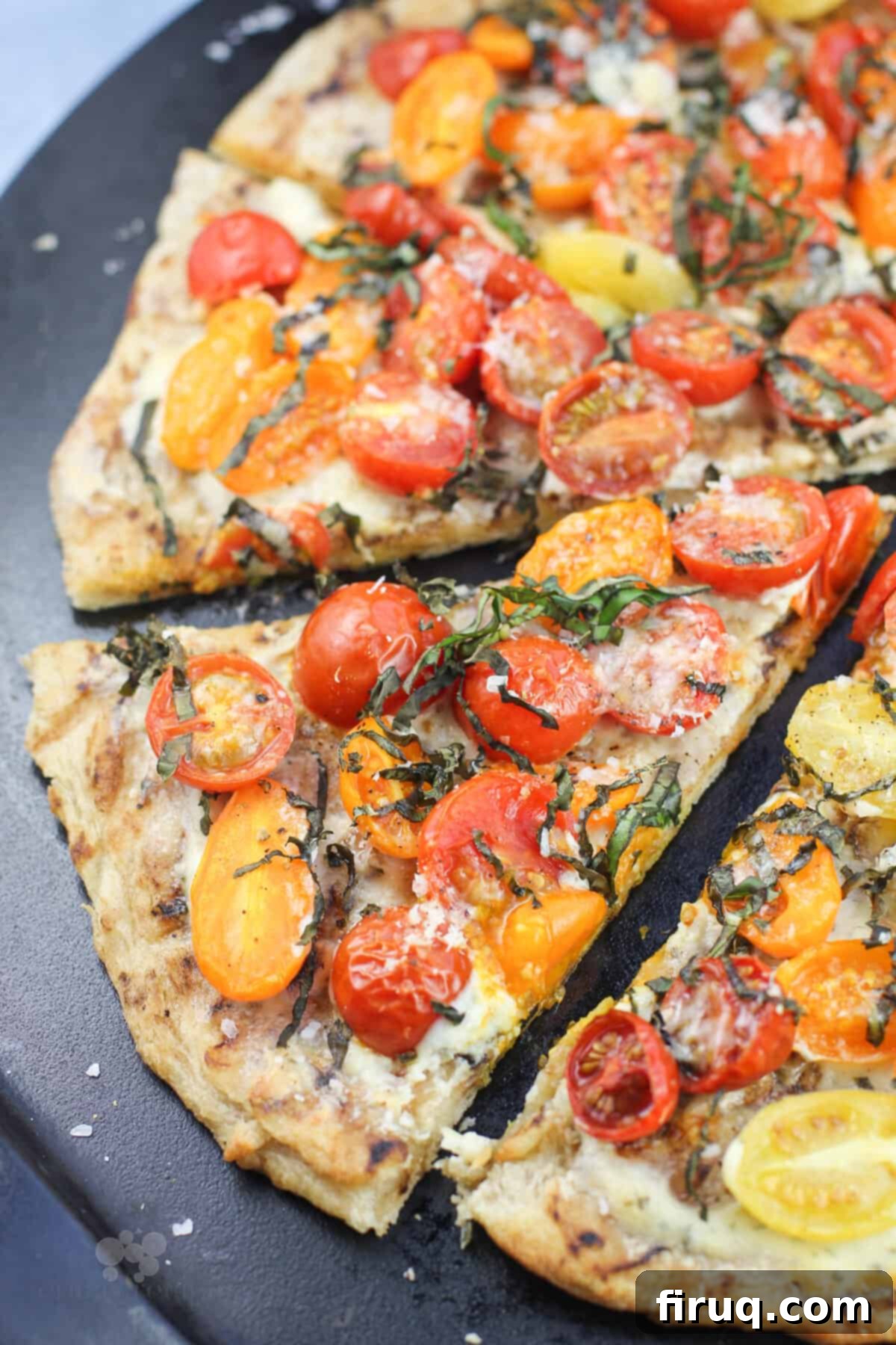 Boursin Bliss: Tomato Basil Pizza 9 slice of pizza, close view on pizza stone