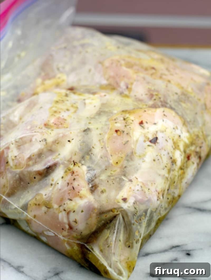 Crispy Greek Air Fryer Wings 4 chicken drumettes marinating in a Greek-style lemon herb sauce in a resealable bag