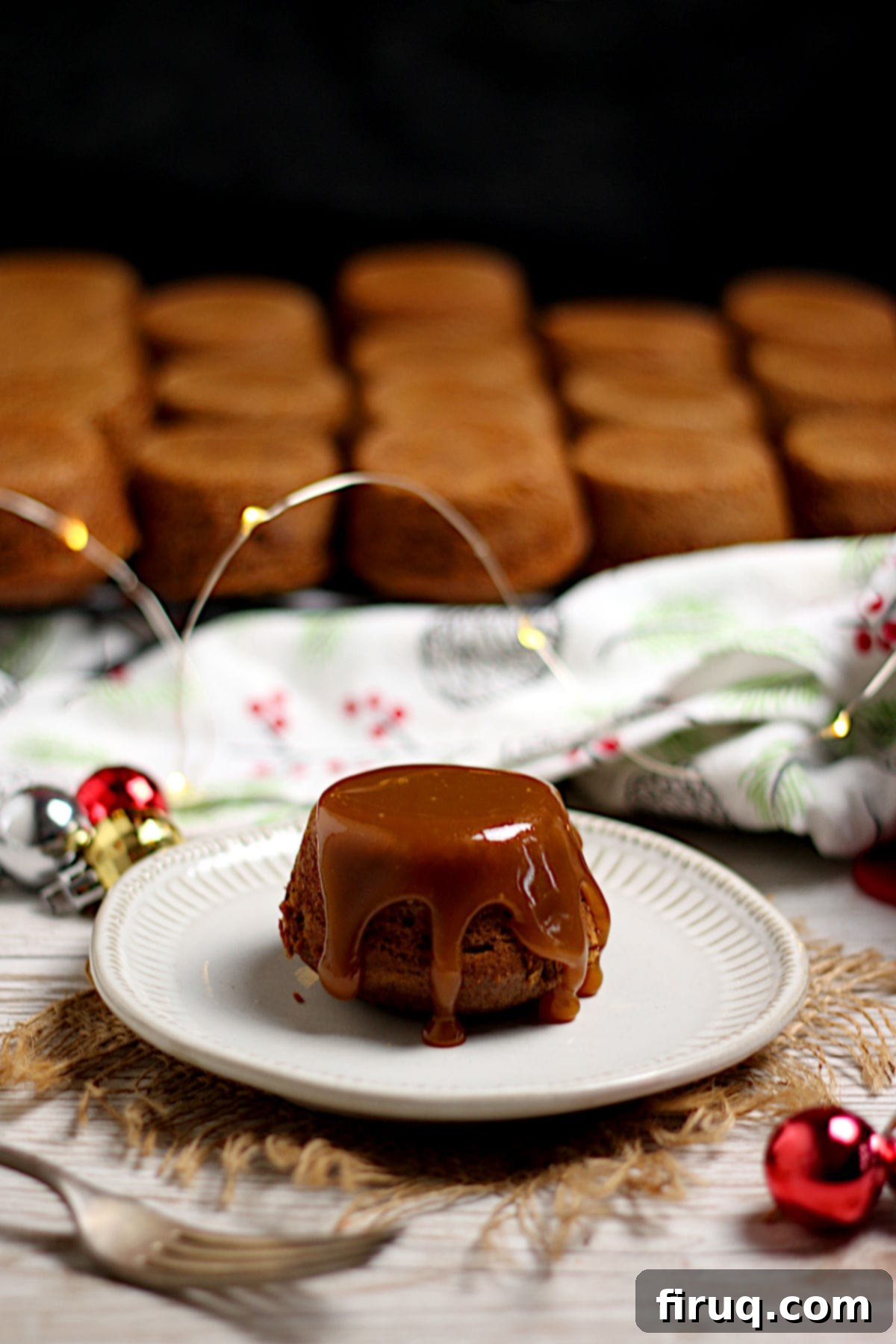 Individual Sticky Toffee Pudding An individual Sticky Toffee Pudding on a small plate.