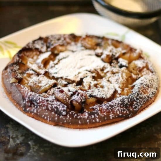 German Apple Pancake Hero Shot A freshly baked German Apple Pancake, golden brown and puffed high, presented beautifully.