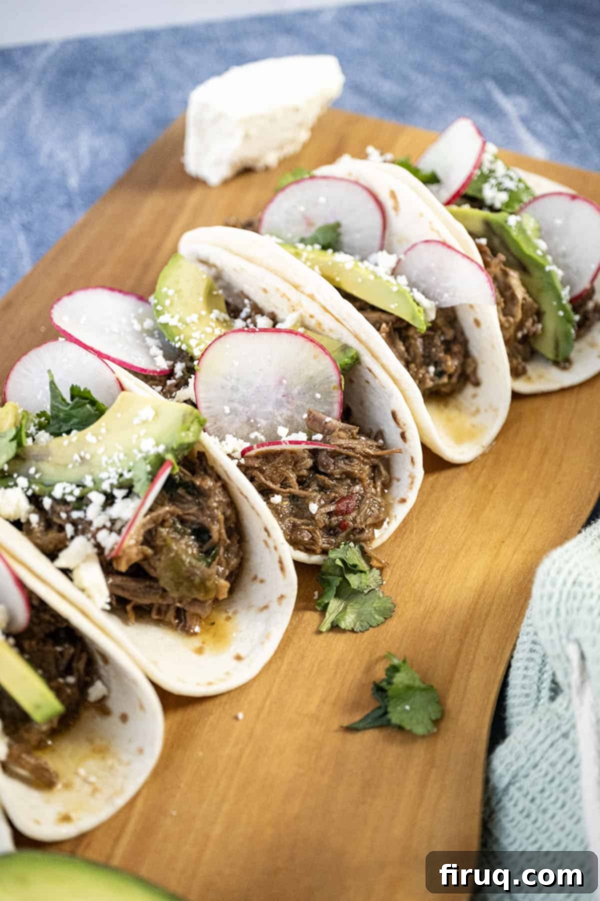 Ultimate Dutch Oven Barbacoa Tacos 9 Beef barbacoa tacos with sliced radish, avocado, and cotija cheese.