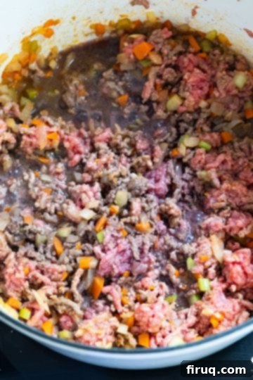 Classic Italian Stuffed Peppers in Tomato Sauce 6 Partially browned ground beef in the dutch oven, ready for deglazing
