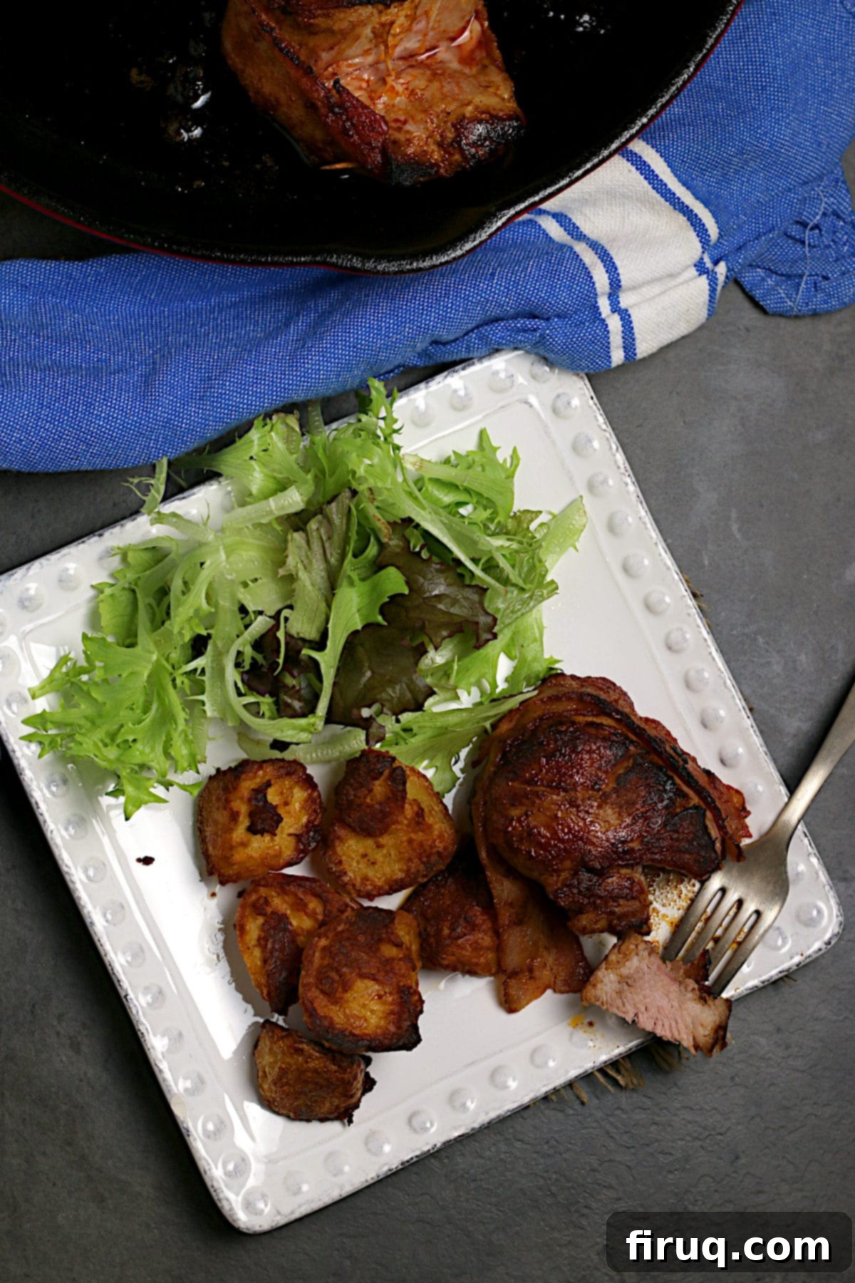 Bacon Wrapped Pork Medallion with Roasted Veggies A beautifully plated Bacon Wrapped Pork Medallion, perfectly browned, next to a medley of roasted vegetables.