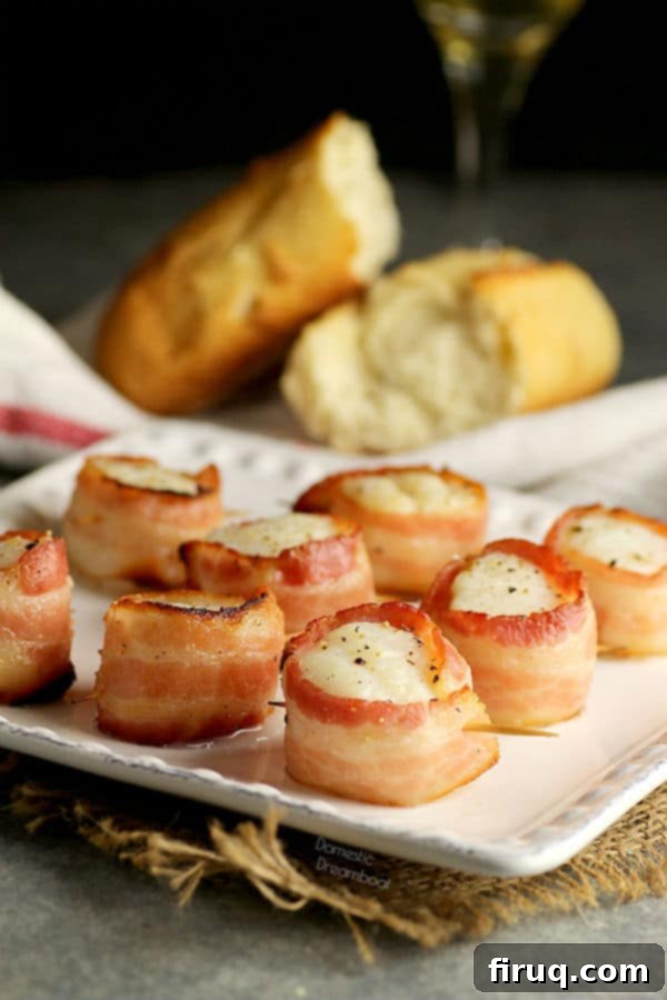 Perfect Bacon Wrapped Scallops Bacon wrapped scallops perfectly seared on a plate.