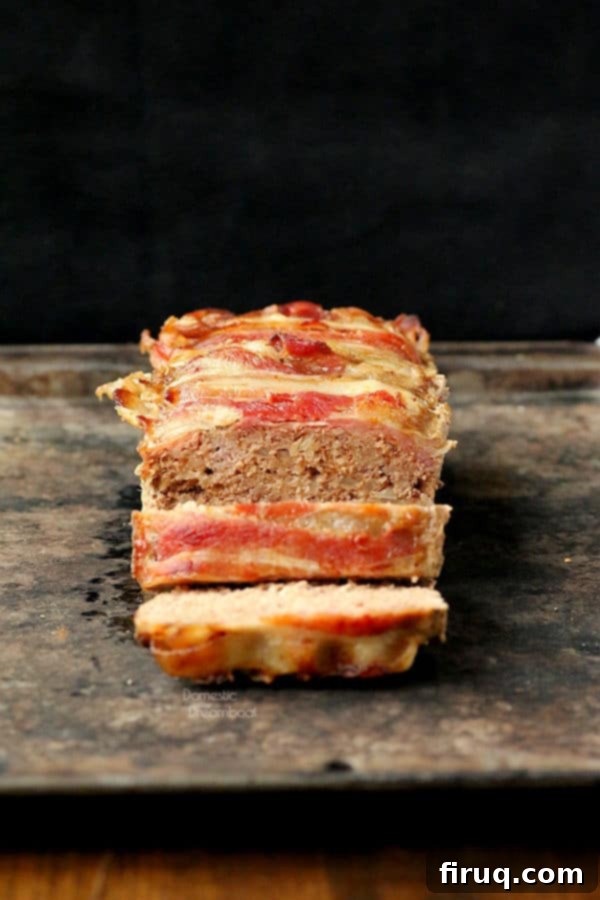 Bacon Wrapped Meatloaf Slices Slices of a delicious Bacon Wrapped Meatloaf, showing the juicy meat and crispy bacon crust.