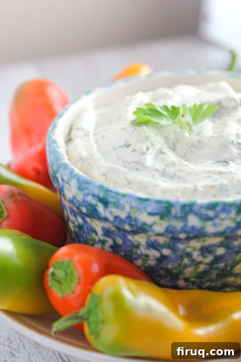 Forget Ranch This Is the Only Veggie Dip You Need 2 side view of dip in blue crock surrounded by fresh vegetables
