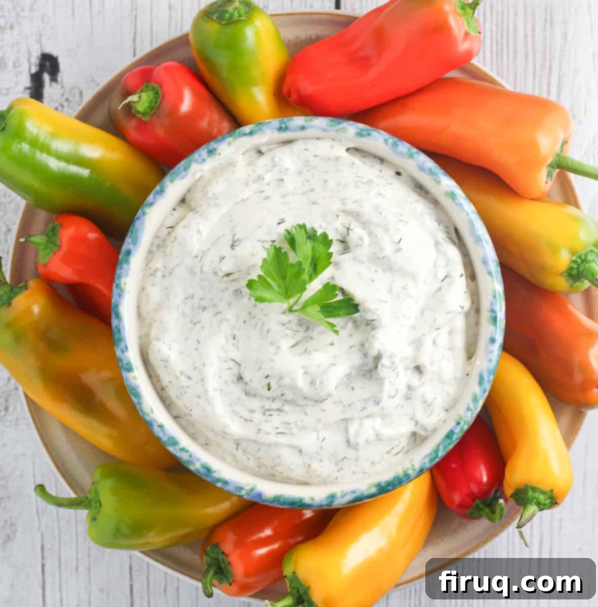 Forget Ranch This Is the Only Veggie Dip You Need 5 top down view of dip in blue crock surrounded by snack peppers