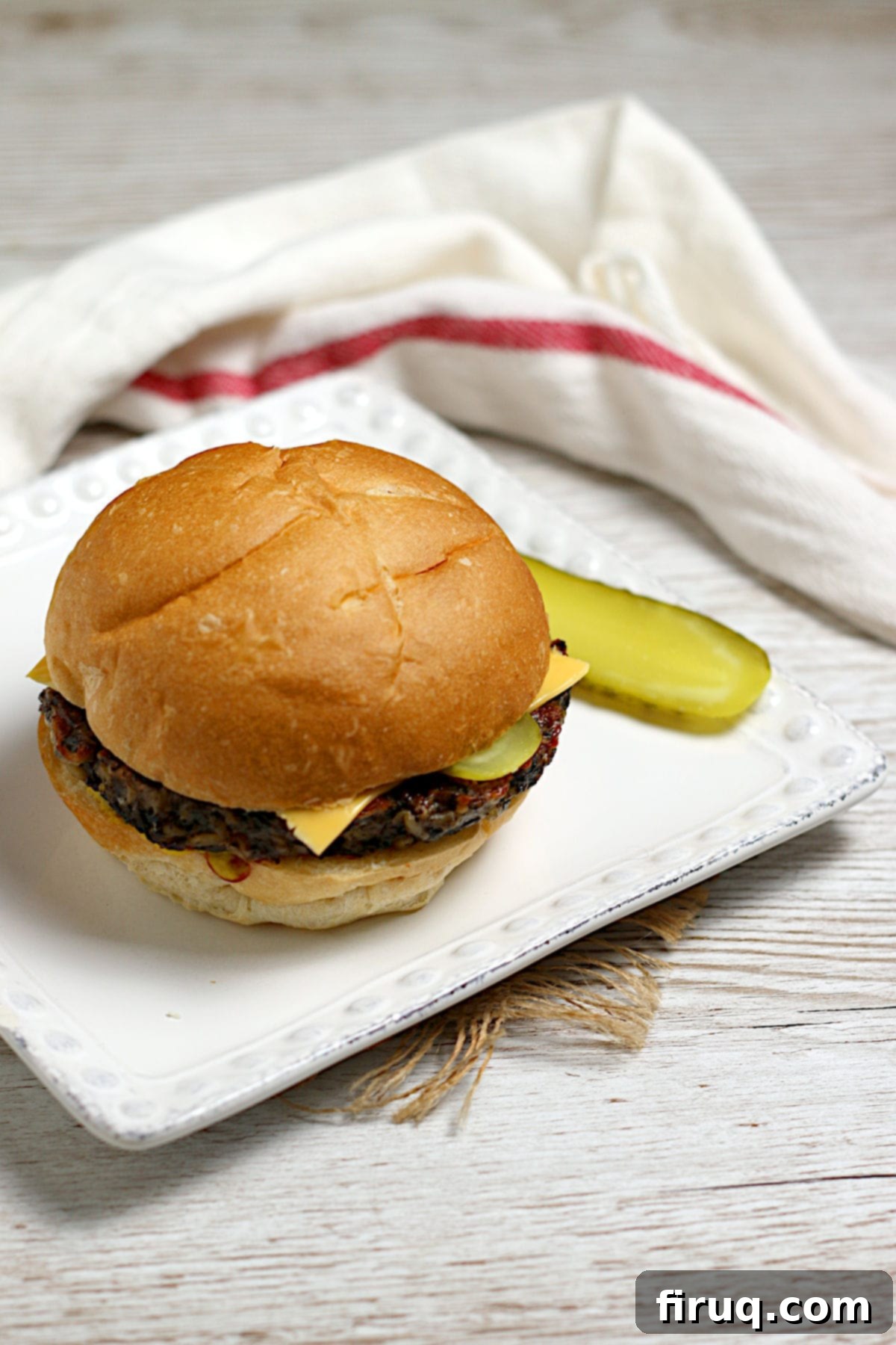 Freshly prepared Mushroom Grain Veggie Burger A close-up of a Mushroom Grain Veggie Burger showing its texture and ingredients.